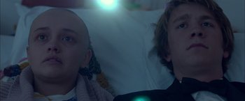 Movie still from “Me and Earl and the Dying Girl” (2015), directed by Alfonso Gomez-Rejon – Two people sitting on a bed in a room; Close Up shot, Over the shoulder angle