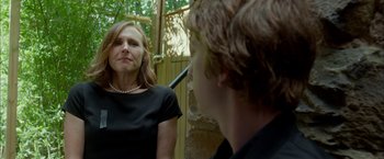 Movie still from “Me and Earl and the Dying Girl” (2015), directed by Alfonso Gomez-Rejon – A woman looking at herself in the mirror; Medium shot, Over the shoulder angle