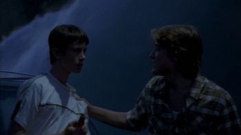 Movie still from “Mean Creek” (2004), directed by Jacob Estes – Two young men are talking to each other; Medium shot, Low angle