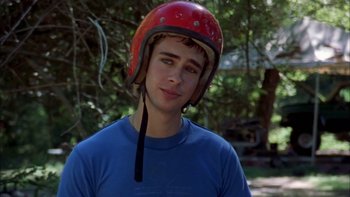 Movie still from “Mean Creek” (2004), directed by Jacob Estes – A young man wearing a red motorcycle helmet; Close Up shot, Over the shoulder angle
