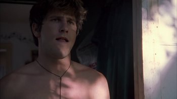 Movie still from “Mean Creek” (2004), directed by Jacob Estes – A man with a necklace is looking at his reflection in a mirror; Close Up shot, Low angle