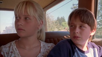 Movie still from “Mean Creek” (2004), directed by Jacob Estes – A young boy and a young girl sitting in the back seat of a car; Close Up shot, Low angle