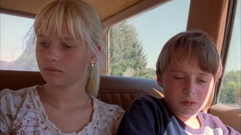 Movie still from “Mean Creek” (2004), directed by Jacob Estes – Two young children sitting in the back seat of a car; Close Up shot, Low angle