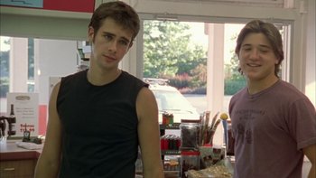 Movie still from “Mean Creek” (2004), directed by Jacob Estes – Two young men standing next to each other in front of a window; Medium shot, Over the shoulder angle