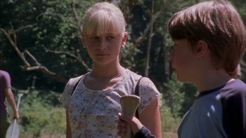 Movie still from “Mean Creek” (2004), directed by Jacob Estes – A young girl and a young boy standing next to each other in a forest; Close Up shot, Over the shoulder angle