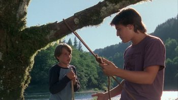 Movie still from “Mean Creek” (2004), directed by Jacob Estes – Two young boys are playing tug - o - war on a rope; Medium shot, Low angle