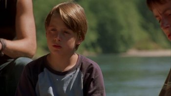 Movie still from “Mean Creek” (2004), directed by Jacob Estes – A young boy standing in front of a body of water; Close Up shot, Low angle