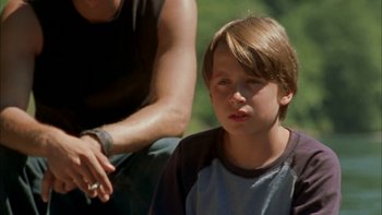 Movie still from “Mean Creek” (2004), directed by Jacob Estes – A young boy sitting next to an older man; Close Up shot, High angle