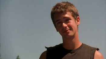 Movie still from “Mean Creek” (2004), directed by Jacob Estes – A young man smiles for the camera; Close Up shot, Low angle