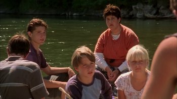 Movie still from “Mean Creek” (2004), directed by Jacob Estes – A group of young people sitting on a boat in the water; Medium shot, High angle