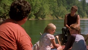 Movie still from “Mean Creek” (2004), directed by Jacob Estes – A young girl sitting on a boat in the water; Medium shot, Over the shoulder angle
