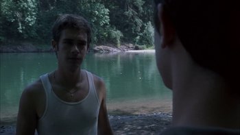 Movie still from “Mean Creek” (2004), directed by Jacob Estes – Two young men standing next to a body of water; Medium shot, Over the shoulder angle