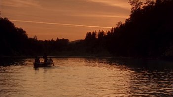 Movie still from “Mean Creek” (2004), directed by Jacob Estes – Two people in a boat on a lake at sunset; Extreme Wide shot, Low angle