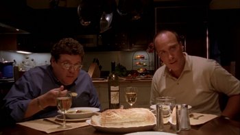 Movie still from “Mean Creek” (2004), directed by Jacob Estes – Two men sitting at a dinner table with a loaf of bread; Medium shot, High angle