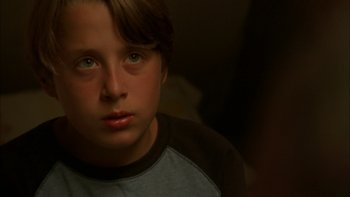 Movie still from “Mean Creek” (2004), directed by Jacob Estes – A young boy is looking into the camera; Close Up shot, Over the shoulder angle