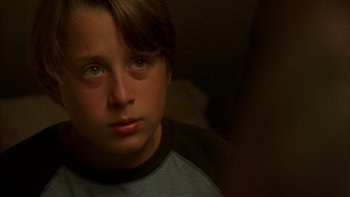 Movie still from “Mean Creek” (2004), directed by Jacob Estes – A young boy is looking into the camera; Close Up shot, Over the shoulder angle