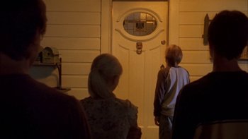 Movie still from “Mean Creek” (2004), directed by Jacob Estes – Two people standing in front of an open door; Medium shot, Over the shoulder angle