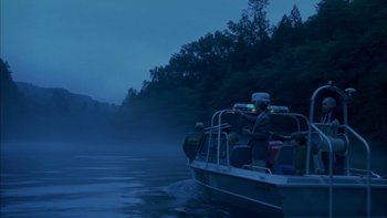 Movie still from “Mean Creek” (2004), directed by Jacob Estes – A group of people in a boat on a body of water at night; Extreme Wide shot, Low angle