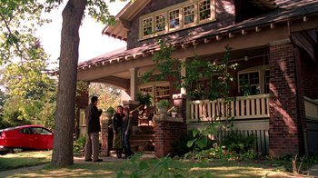 Movie still from “Mean Girls” (2004), directed by Mark Waters – A group of people standing in front of a house; Wide shot, Low angle