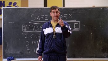 Movie still from “Mean Girls” (2004), directed by Mark Waters – A man standing in front of a chalkboard; Wide shot, High angle