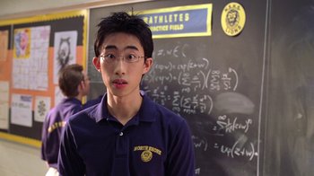Movie still from “Mean Girls” (2004), directed by Mark Waters – A young man standing in front of a chalkboard; Close Up shot, High angle