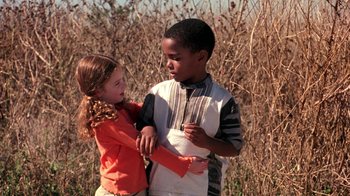Movie still from “Mean Girls” (2004), directed by Mark Waters – A young boy and a young girl standing next to each other; Medium shot, High angle
