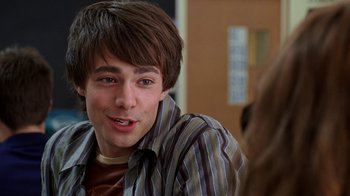 Movie still from “Mean Girls” (2004), directed by Mark Waters – A young man sitting in front of a wall; Close Up shot, Over the shoulder angle