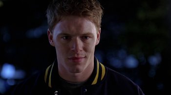 Movie still from “Mean Girls” (2004), directed by Mark Waters – A young man in a blue and yellow jacket; Close Up shot, Low angle