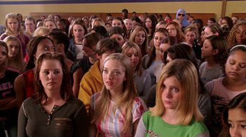 Movie still from “Mean Girls” (2004), directed by Mark Waters – A group of people standing in a large room; Medium shot, High angle