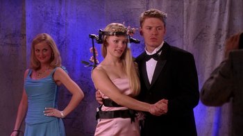 Movie still from “Mean Girls” (2004), directed by Mark Waters – A man and a woman dressed in formal wear; Medium shot, Low angle