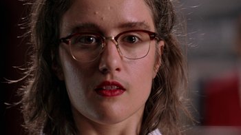 Movie still from “Mean Girls” (2004), directed by Mark Waters – A person wearing glasses and a white shirt; Close Up shot, Low angle