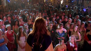 Movie still from “Mean Girls” (2004), directed by Mark Waters – A group of people in a room with a woman in front of them; Wide shot, High angle