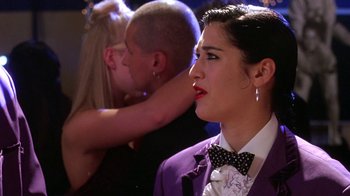 Movie still from “Mean Girls” (2004), directed by Mark Waters – A woman wearing a purple jacket and a bow tie; Close Up shot, Over the shoulder angle
