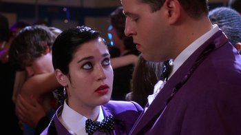 Movie still from “Mean Girls” (2004), directed by Mark Waters – A man and a woman dressed up in purple; Close Up shot, Over the shoulder angle