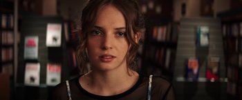 Movie still from “Fear Street: Part One - 1994” (2021), directed by Leigh Janiak – A person wearing a black shirt; Close Up shot, Over the shoulder angle