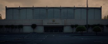 Movie still from “Fear Street: Part One - 1994” (2021), directed by Leigh Janiak – A building that has a sign on the side of it; Extreme Wide shot, High angle