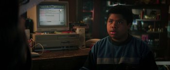 Movie still from “Fear Street: Part One - 1994” (2021), directed by Leigh Janiak – A young boy sitting in front of a computer monitor; Close Up shot, High angle