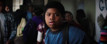 Movie still from “Fear Street: Part One - 1994” (2021), directed by Leigh Janiak – A young boy with a backpack and a blue shirt; Close Up shot, Over the shoulder angle