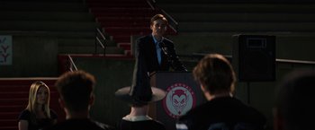 Movie still from “Fear Street: Part One - 1994” (2021), directed by Leigh Janiak – A man is giving a speech in front of an audience; Medium shot, Over the shoulder angle