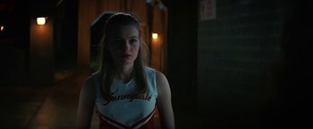 Movie still from “Fear Street: Part One - 1994” (2021), directed by Leigh Janiak – A woman in a cheerleader uniform standing in the dark; Close Up shot, Low angle