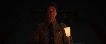 Movie still from “Fear Street: Part One - 1994” (2021), directed by Leigh Janiak – A man in a police uniform with a flashlight; Close Up shot, Low angle