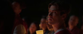 Movie still from “Fear Street: Part One - 1994” (2021), directed by Leigh Janiak – A group of people sitting in a dark room; Close Up shot, Over the shoulder angle