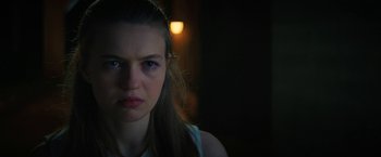 Movie still from “Fear Street: Part One - 1994” (2021), directed by Leigh Janiak – A young woman with long brown hair stares into the camera; Close Up shot, Over the shoulder angle