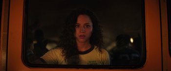 Movie still from “Fear Street: Part One - 1994” (2021), directed by Leigh Janiak – A woman with curly hair looking out of a window; Close Up shot, Over the shoulder angle