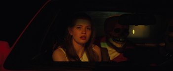 Movie still from “Fear Street: Part One - 1994” (2021), directed by Leigh Janiak – A woman sitting in the back seat of a car; Close Up shot, Over the shoulder angle