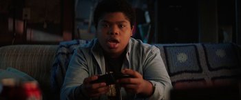 Movie still from “Fear Street: Part One - 1994” (2021), directed by Leigh Janiak – A young man holding a video game controller in his hands; Close Up shot, High angle