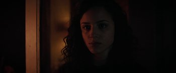 Movie still from “Fear Street: Part One - 1994” (2021), directed by Leigh Janiak – A person in a dark room; Close Up shot, Low angle