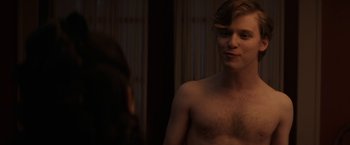 Movie still from “Fear Street: Part One - 1994” (2021), directed by Leigh Janiak – A shirtless man looking into a mirror in front of a woman; Medium shot, Over the shoulder angle