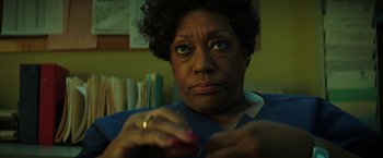 Movie still from “Fear Street: Part One - 1994” (2021), directed by Leigh Janiak – An older black woman looking at the camera; Close Up shot, Low angle