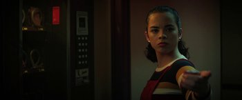 Movie still from “Fear Street: Part One - 1994” (2021), directed by Leigh Janiak – A woman standing next to an elevator in a dark room; Close Up shot, Low angle